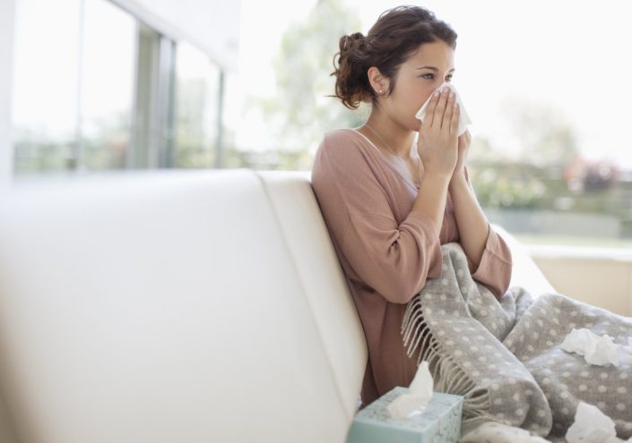 woman-sneezing-couch